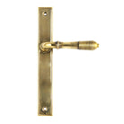 From The Anvil's Aged Brass Reeded Slimline Lever Espag. Latch Set