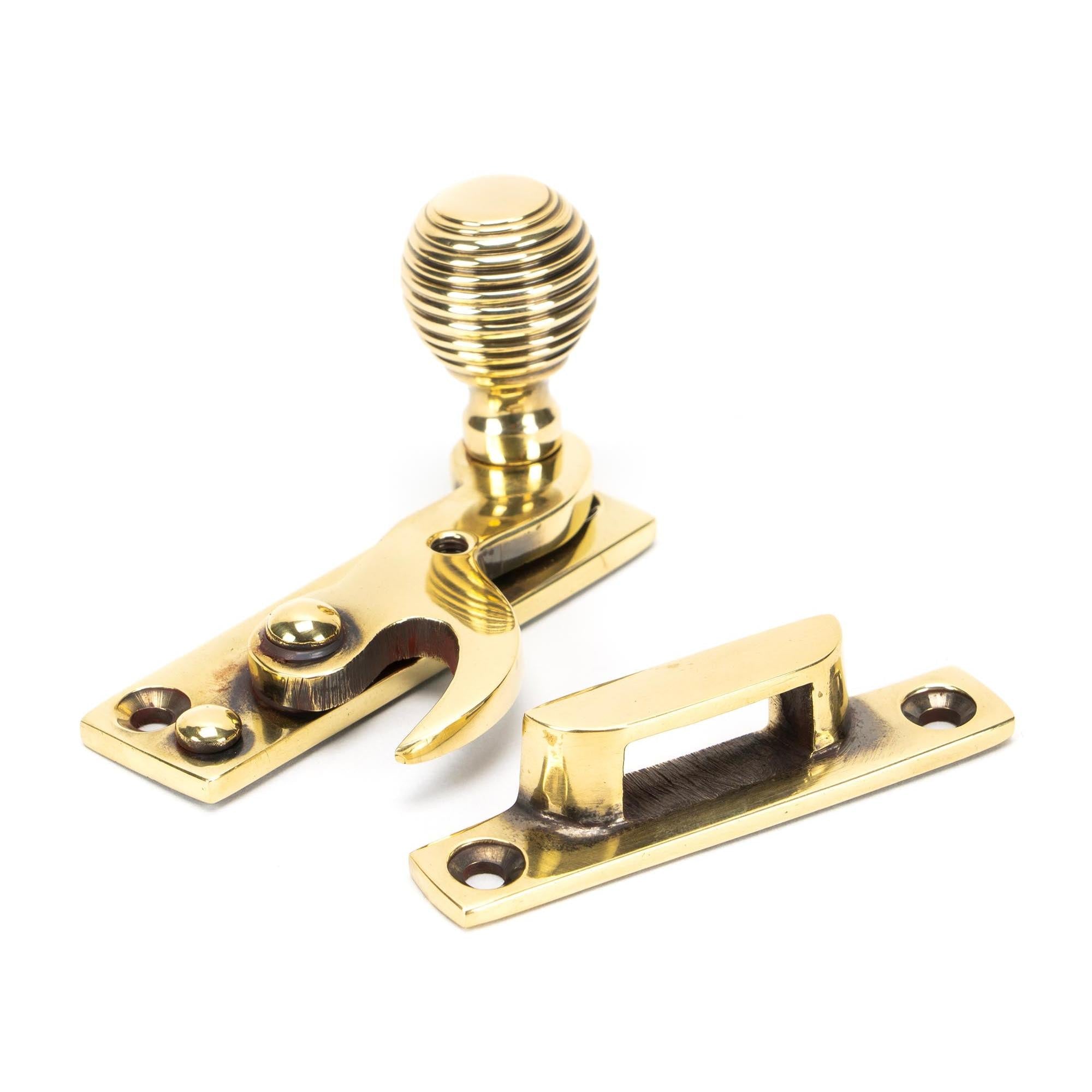 From The Anvil's Aged Brass Beehive Sash Hook Fastener